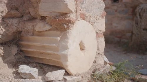 Ancient Ruins of a Stone Column in Sunny Archaeological Site