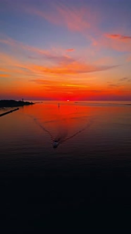 Aerial Footage of a Serene Sunset Over the Calm Waters of the Ocean Showcasing Vibrant Colors and