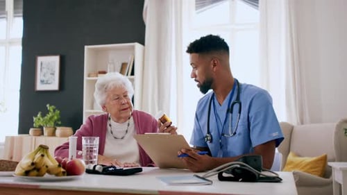 Friendly Caregiver Consulting Senior Woman About Medication