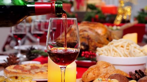 Red Wine Poured at Festive Holiday Dinner
