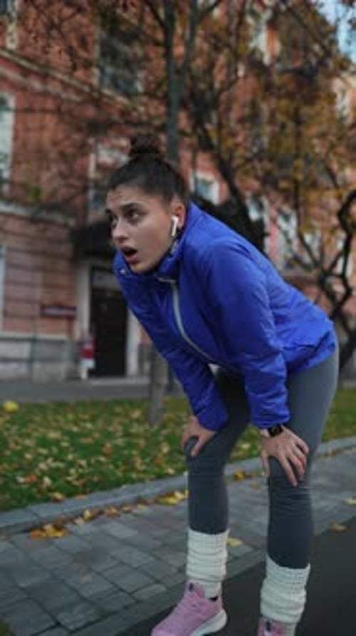 Tired Runner Woman Breathing After Run in City Street