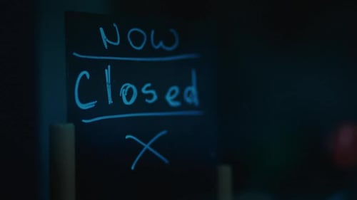 Handwritten Now Closed in Electric Blue Chalk on Blackboard