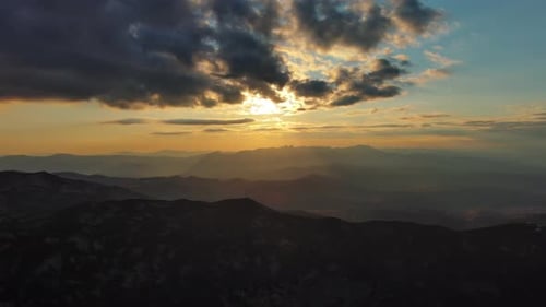 Sunset Over Mountain with Dramatic Clouds