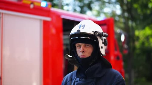 Portrait of Confident Male Fireguard with Dirty Face Standing Near a Fire Engine Young Fireman in