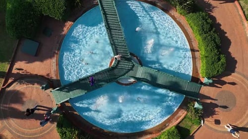 Fountain Top View with a Bridge Over It People Walk and Enjoy Their Holidays in a Large Park Tourist
