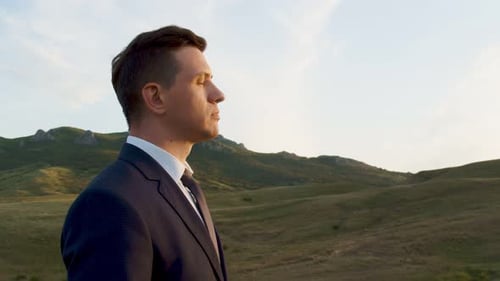 The Face of an Adult Man in Profile A Man in a Suit and Tie Listening the Sound of the Wind in