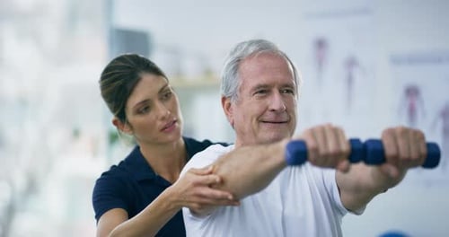 Man Lifts Weights With Help of Therapist