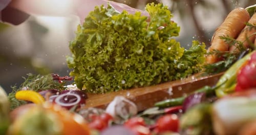 Putting wet lettuce leafs on wooden table