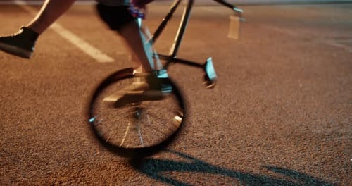 Crop Male BMX Rider Performing Extreme Trick on Street