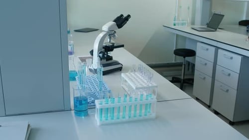Microscope and Test Tubes in Laboratory Workplace