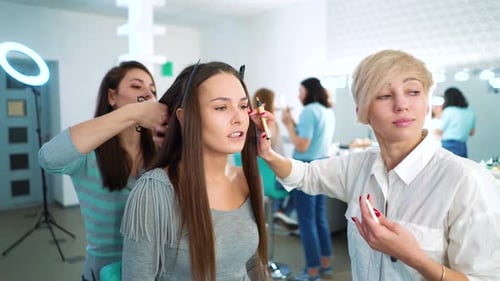Woman Getting Hair and Makeup Done in Salon