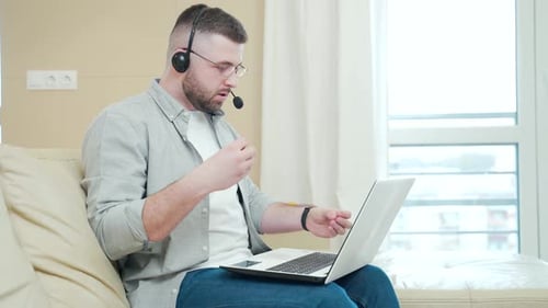 Man Attends Online Meeting at Home Office