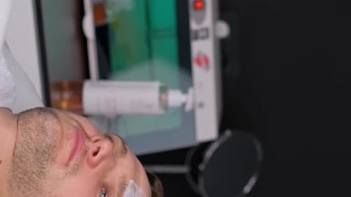 Man Receiving Facial Treatment at Clinic