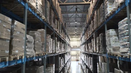 Camera Moves Up On Shelves Of Cardboard Boxes Inside A Storage Warehouse. Industrial Warehouse Wi...