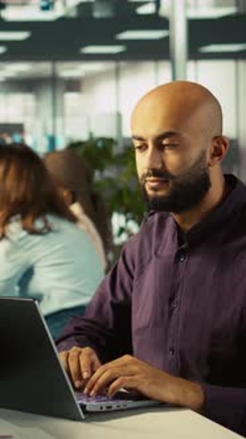 Vertical Video Happy Man in Office Reviewing Financial Graphs Celebrating Positive KPIs