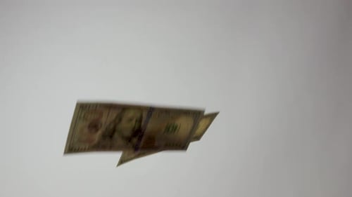 Many U.S.A. One Hundred Dollar Bills Falling In Space On White Background