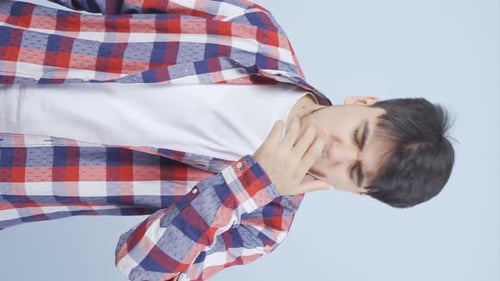 Vertical video of Sick man coughing.