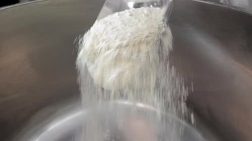 Flour Poured into Stainless Steel Mixing Bowl