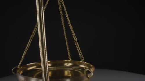 Hanging Golden Weighing Scales Symbolizing Justice