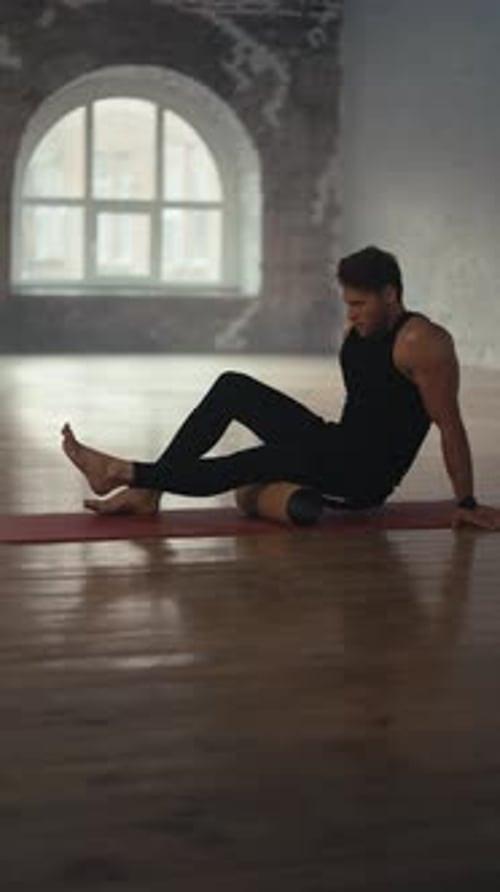 Man Rolls Foam Roller on Leg for Workout