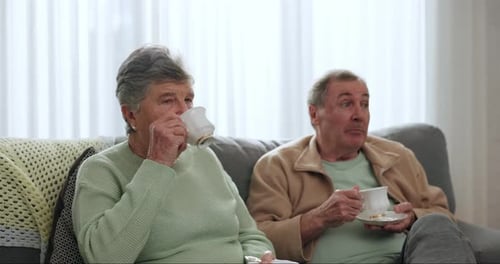 Senior Couple Relaxing and Drinking Tea at Home