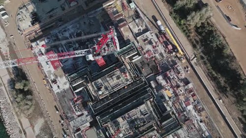Aerial footage of skyscraper construction site with cranes in Athens, Elliniko on seaside