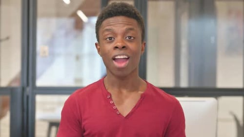 Webcam View of Casual Young African Man Doing Video Chat