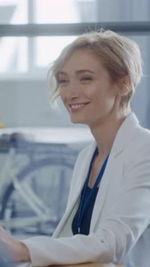 A Confident Businesswoman Smiling Brightly in a Modern Office Environment Full of Energy
