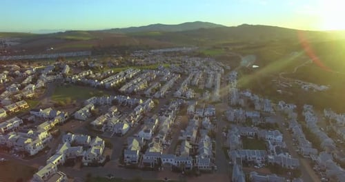 Real estate, houses on hill with sunrise and drone, countryside community with development