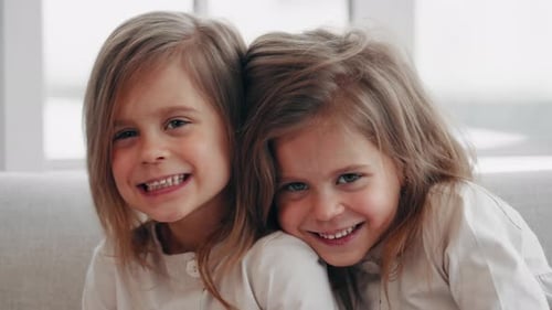 Two Cute Girls Smiling Together Indoors