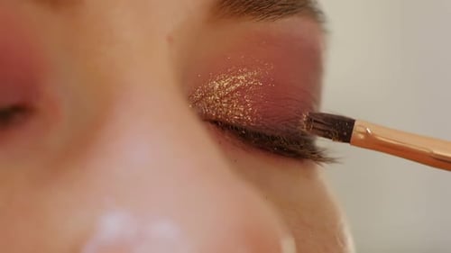 Makeup Artist Applying Eye Shadow Makeup to Model's Eye Close Up View Smoky Eyes Left View Slow