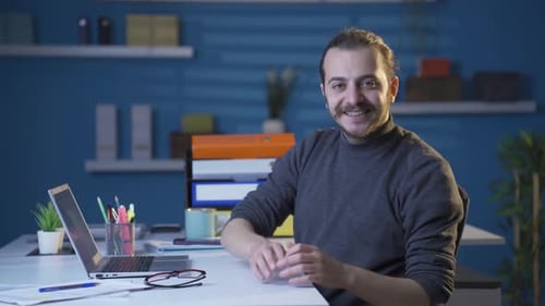 Man at Desk Working on Laptop Computer