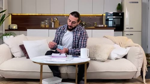 Bearded Man Counting Euro Banknotes Lacking Money to Pay Debts at Home