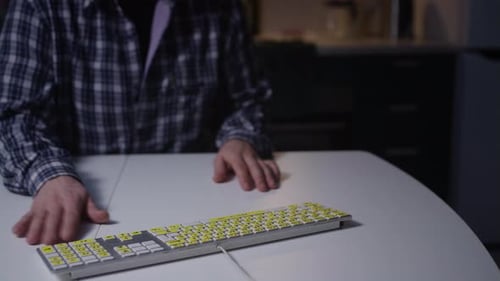 Typing on Keyboard at Night Indoors