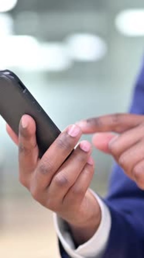 Man in Suit Using Mobile Phone in Office