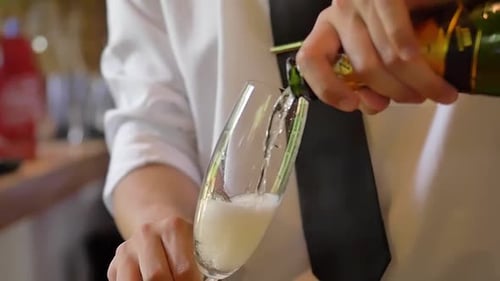 Champagne Pouring into Glass Flute Close Up