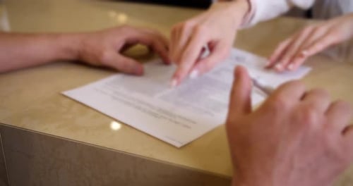 Woman's hands holding a contract or document for signature