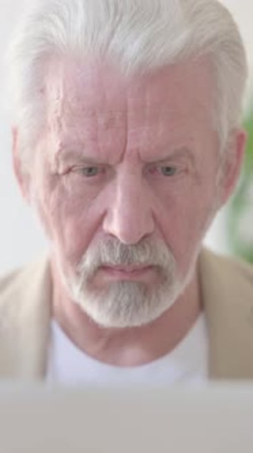 Close Up of Old Man Using Laptop in Office, Vertical Video
