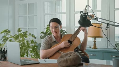 A musician is writing song in home Studio