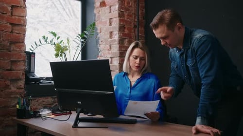 Female Boss And Male Employee Discussing Agreement or Financial Report In Office Annoyed Supervisor
