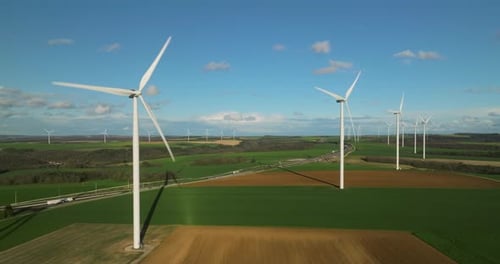 Renewable Energy Source Aerial View of Wind Turbines Standing on the Green Field Aerial View of a