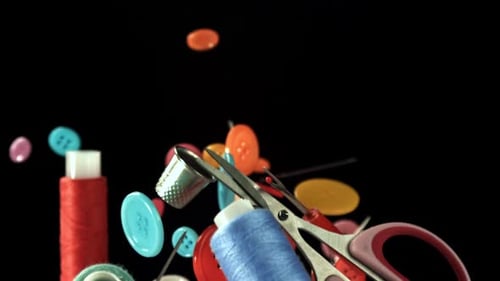 Colorful Sewing Items Floating in the Air on Black