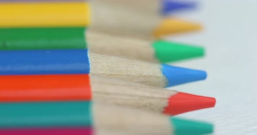 Row of Colorful Pencils on White Surface