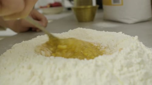 Preparing Dough with Flour and Egg Close Up