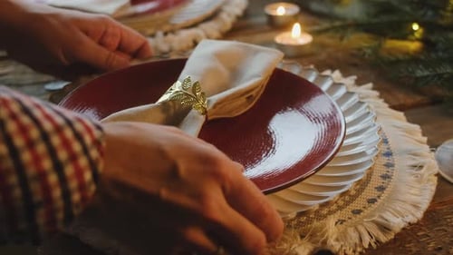 Festive Table Setting with Plates and Candlelight