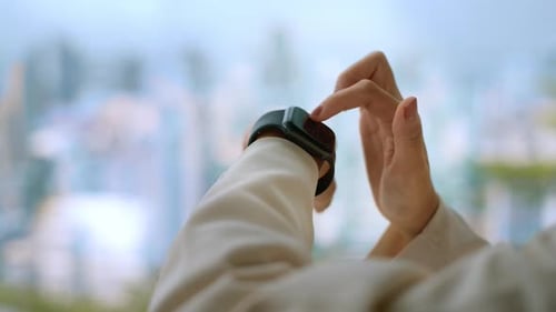 Close up Business woman hands is touching her smart watch