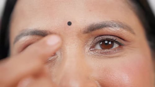 Primer plano de una madre india poniendo bindi