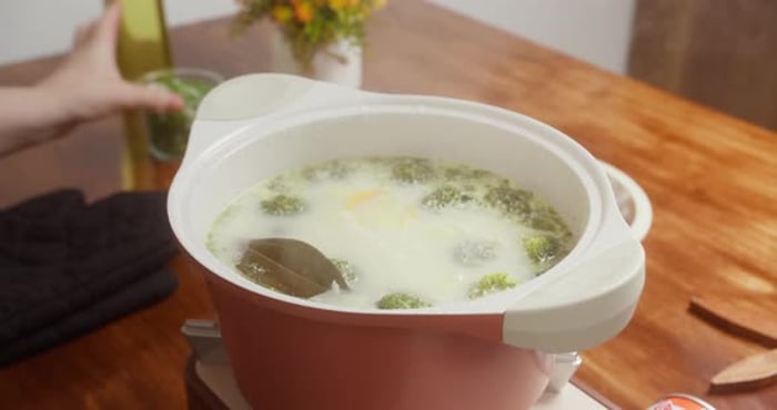 Woman Cooking Broccoli Soup and Adding Chopped Green Onions Female ...
