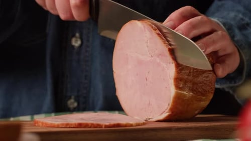 Hands Slicing Tasty Ham on Cutting Board