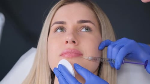 Woman Receives Lip Injection in Hospital Setting